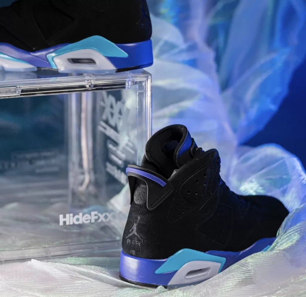 Image displaying the Air Jordan 6 "Aqua" sneakers in a Black, Bright Concord, and Aquatone color scheme, featuring a sleek design with a Black nubuck upper and contrasting accents, resting on an icy translucent outsole.