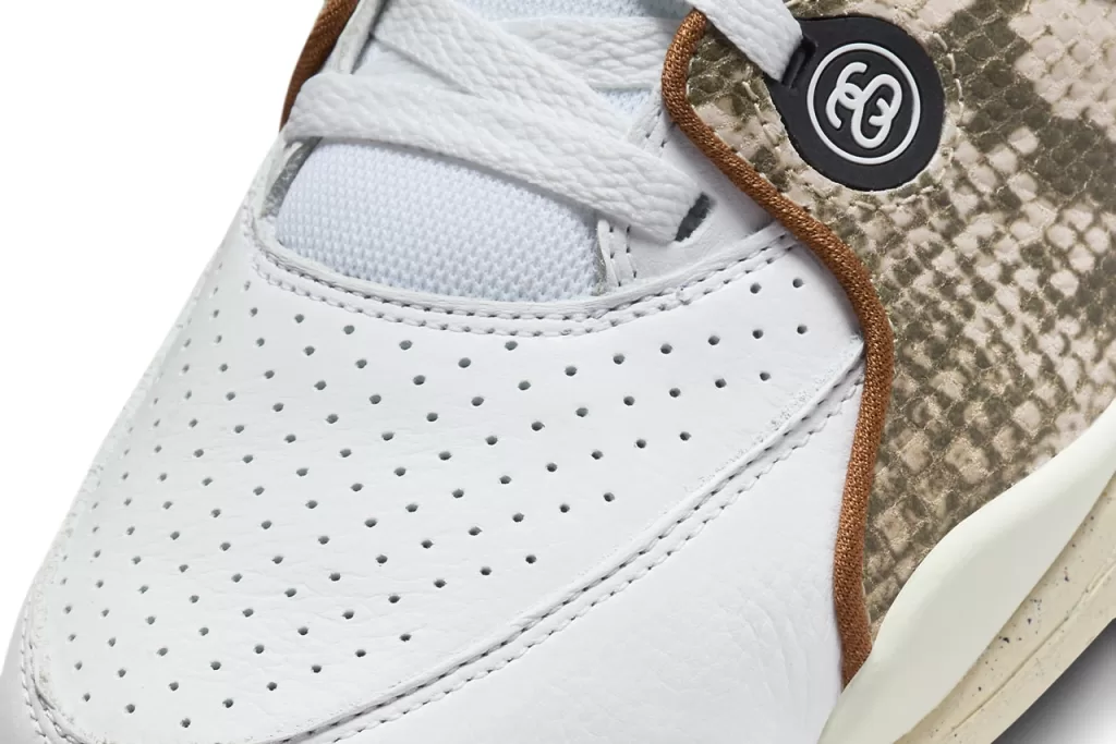 This colorway blends a clean white leather upper with rich pecan brown accents, creating a warm and earthy aesthetic. The snakeskin overlays add a touch of texture and sophistication, while the Air Jordan 4-inspired sole provides a touch of retro charm.