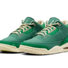 side view of Nina Chanel Abney's highly-anticipated collaboration with Jordan Brand on the Air Jordan 3. This unique design features a two-toned green upper, custom details, and a potential matching apparel collection.